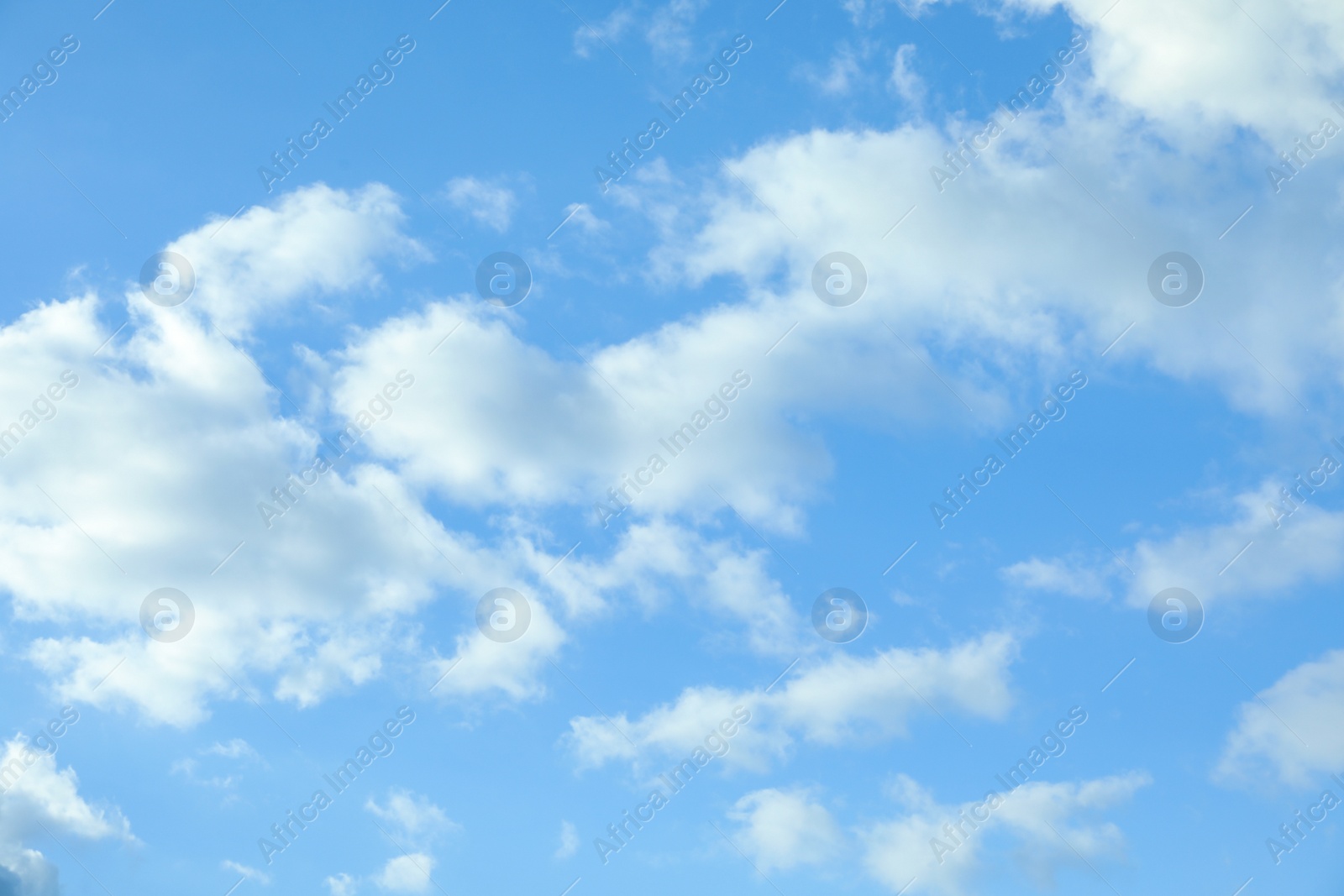 Picturesque view of beautiful blue sky with fluffy white clouds Photo of Picturesque view of beautiful blue sky with fluffy white clouds