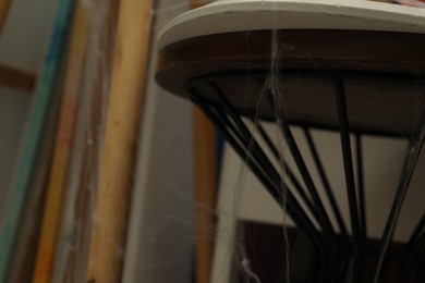 Old cobweb on chair in room, closeup