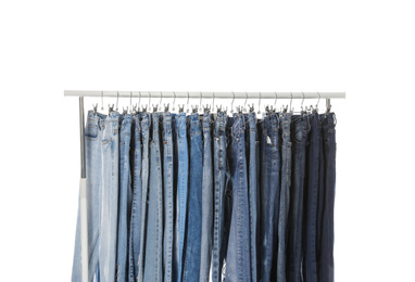 Photo of Rack with different jeans isolated on white