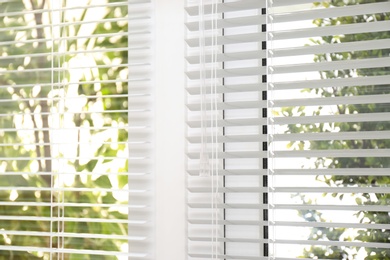 Open white horizontal window blinds, closeup view