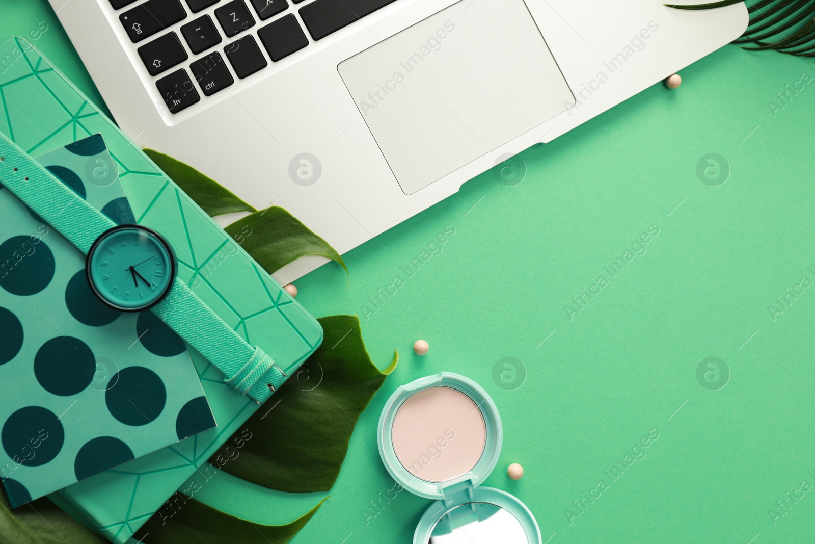 Photo of Flat lay composition with laptop on green background. Fashion blogger