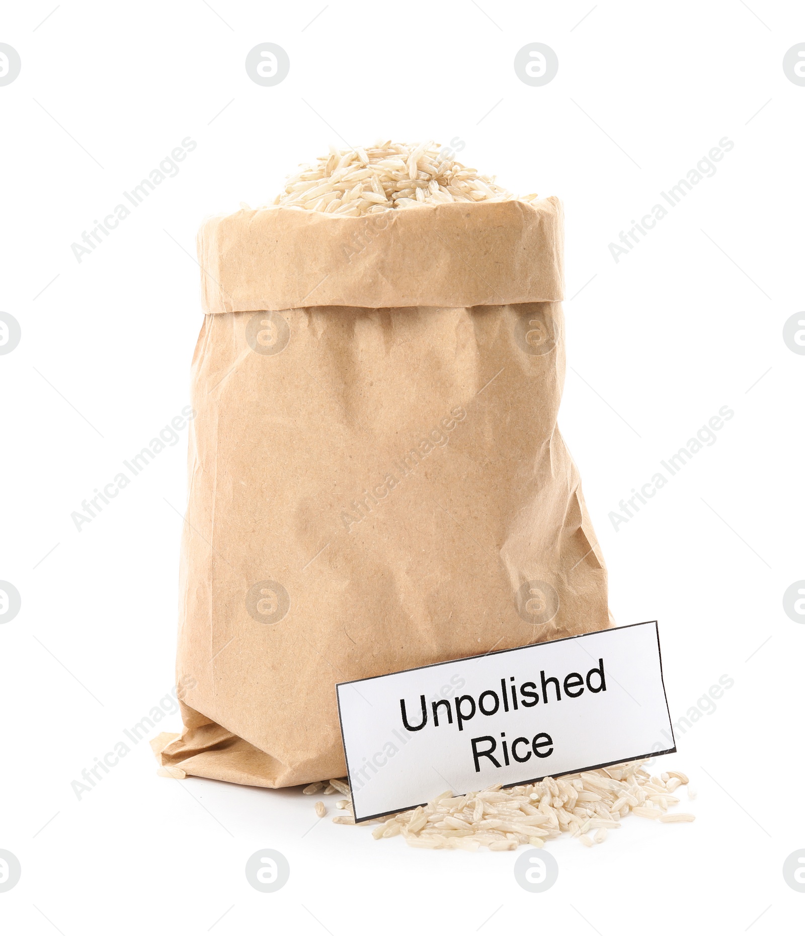 Photo of Paper bag with raw unpolished rice and card on white background