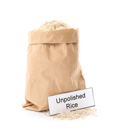 Paper bag with raw unpolished rice and card on white background