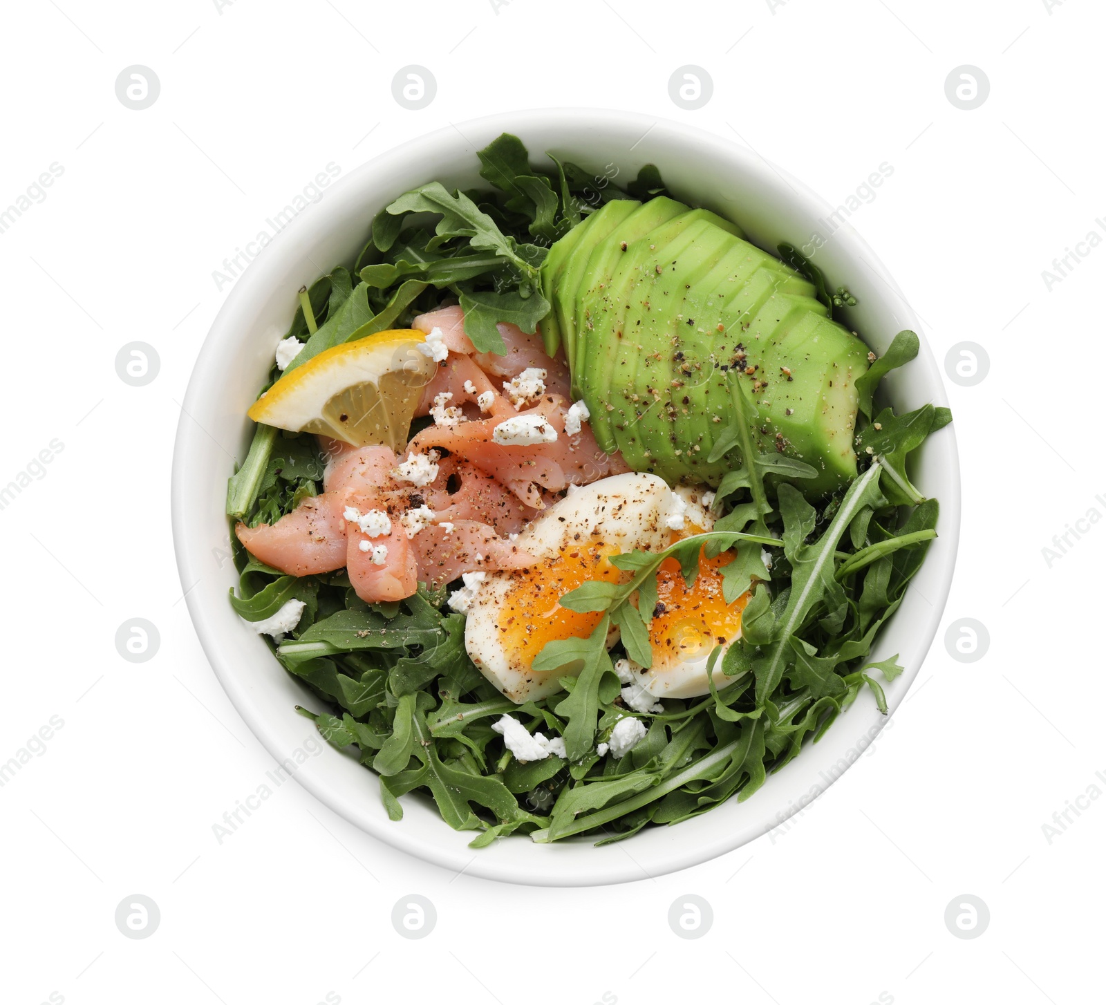 Photo of Delicious salad with boiled egg, salmon and avocado in bowl isolated on white, top view