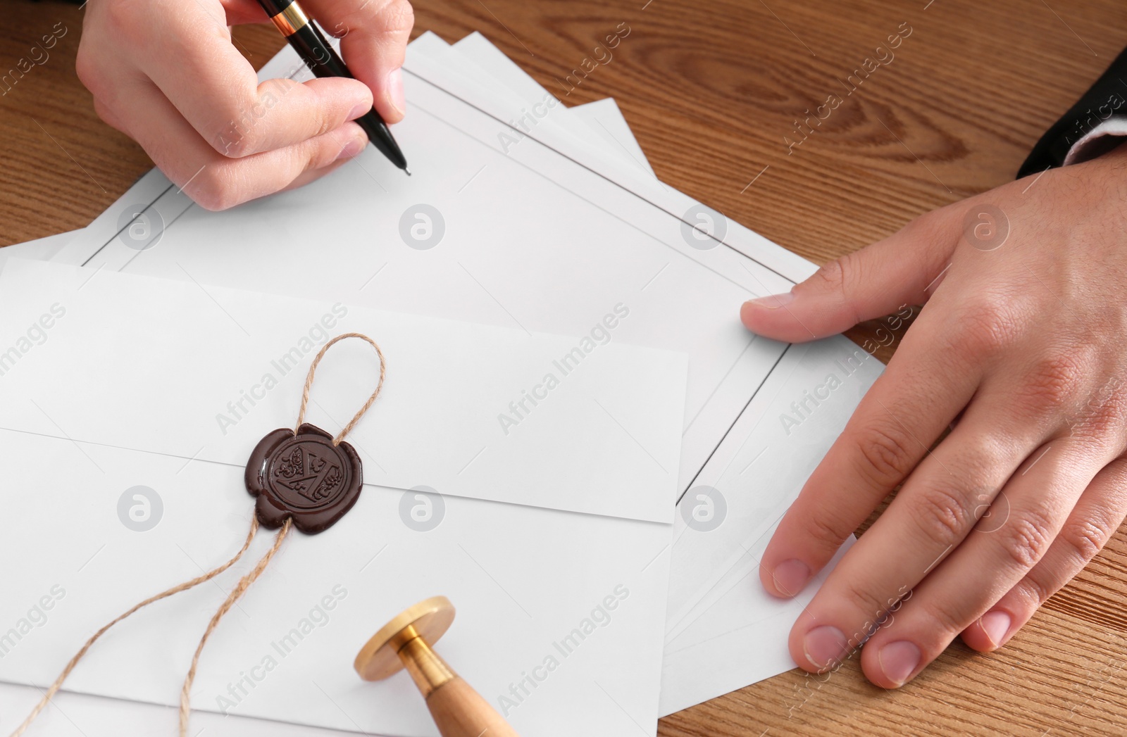 Photo of Male notary working with documents at wooden table, closeup