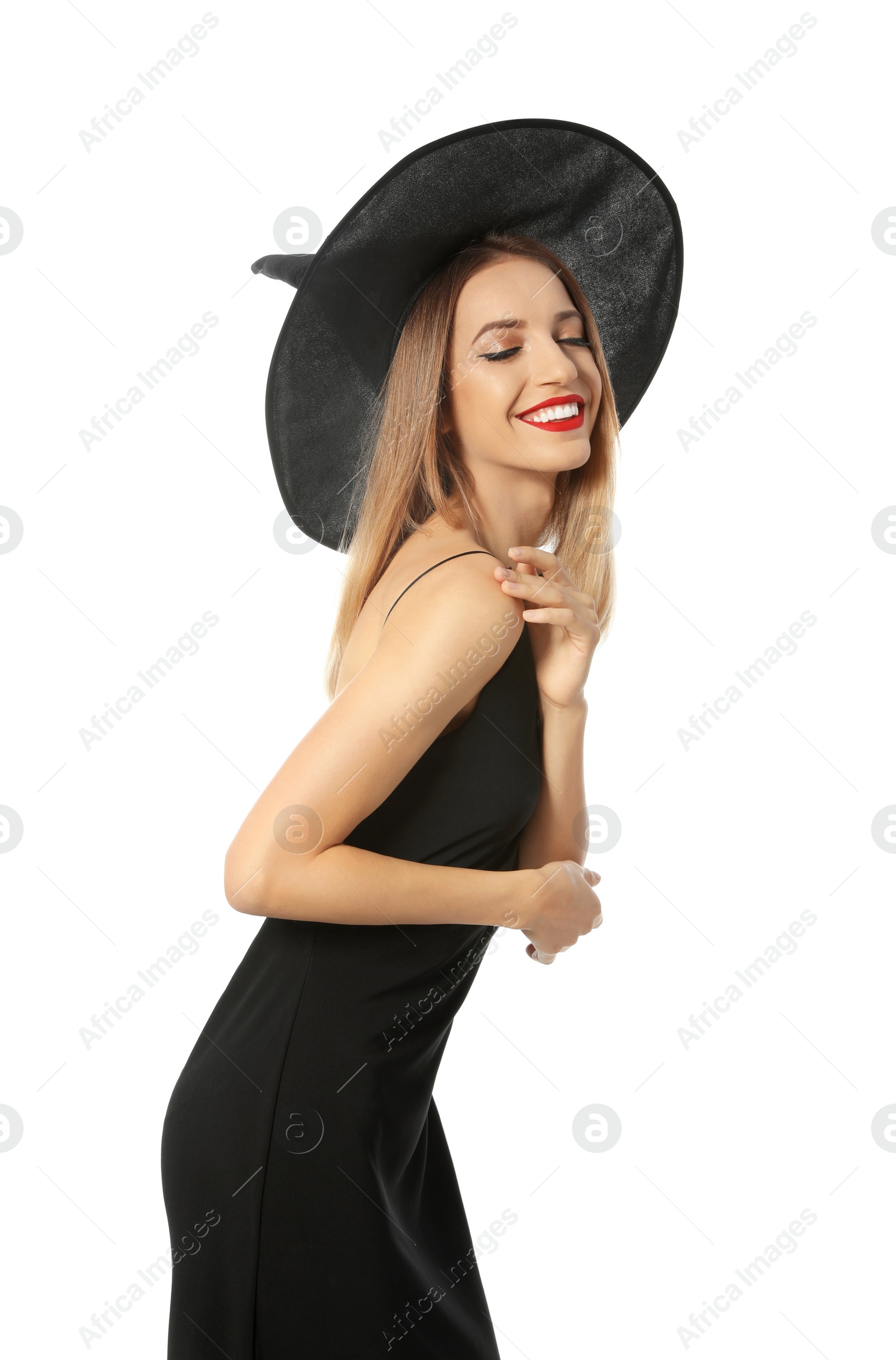 Photo of Beautiful young woman wearing witch costume for Halloween party on white background