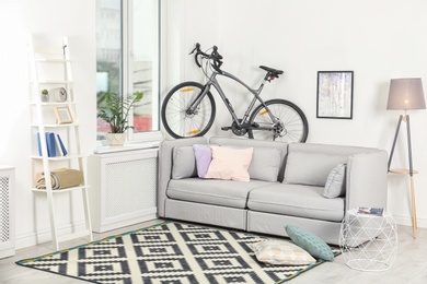 Photo of Modern living room interior with bicycle near wall