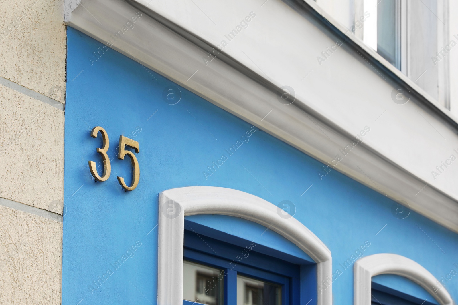 Photo of Plate with house number thirty five on beautiful building outdoors