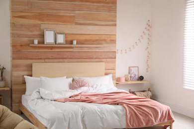 Photo of Stylish room interior with big comfortable bed