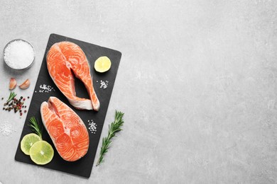 Photo of Fresh salmon and ingredients for marinade on light grey table, flat lay. Space for text
