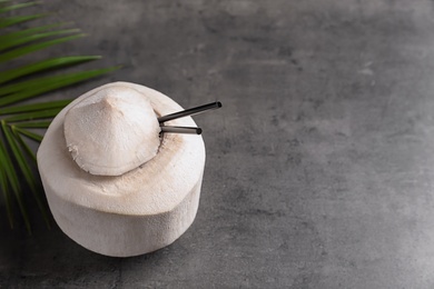 Photo of Fresh coconut drink in nut on grey background