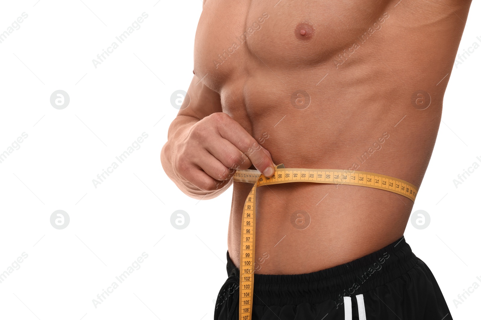 Photo of Athletic man measuring waist with tape on white background, closeup. Weight loss concept