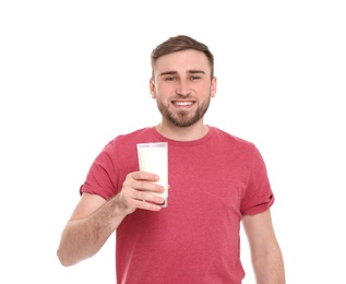 Young man with glass of tasty milk on white background