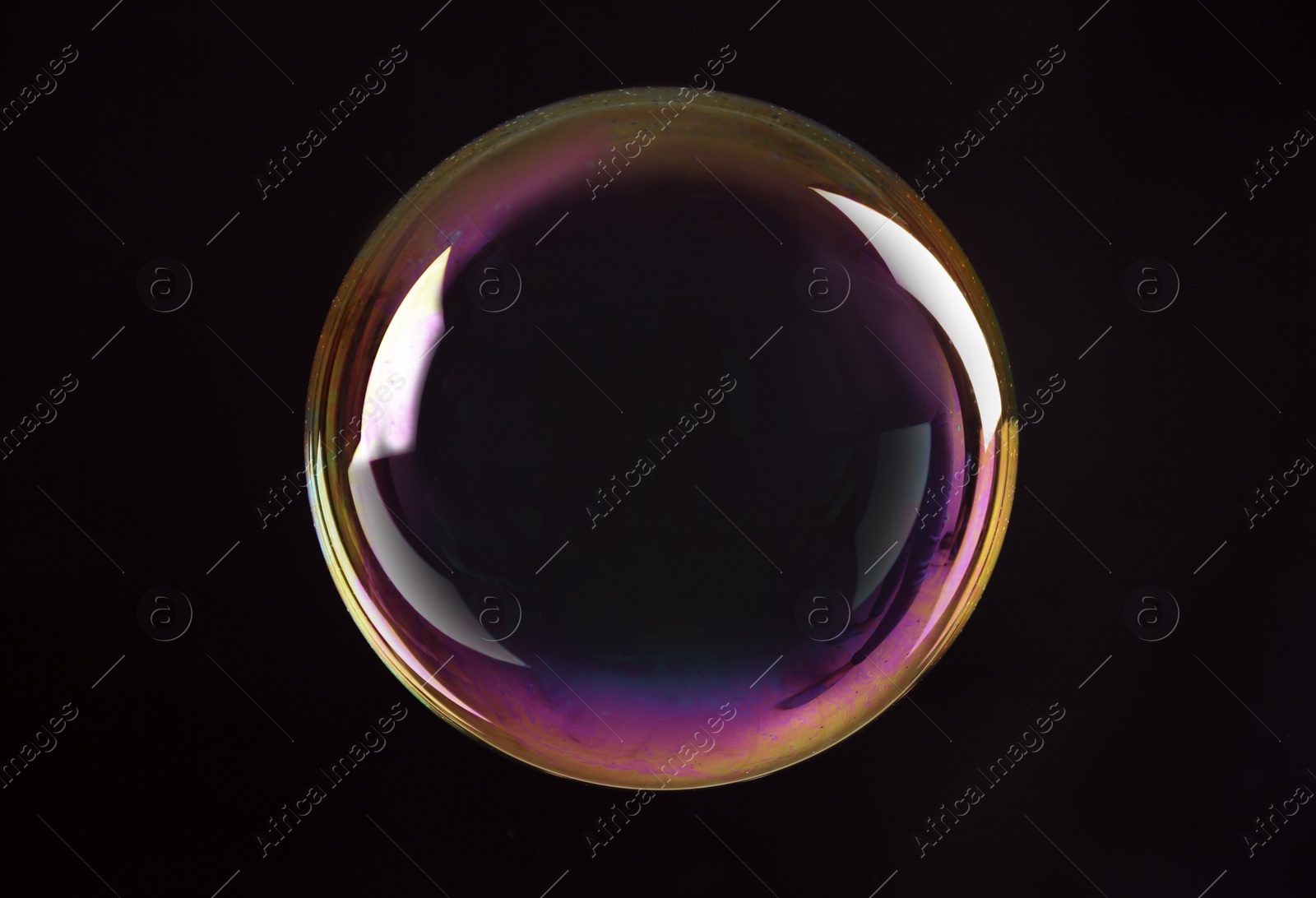 Photo of Beautiful translucent soap bubble on dark background