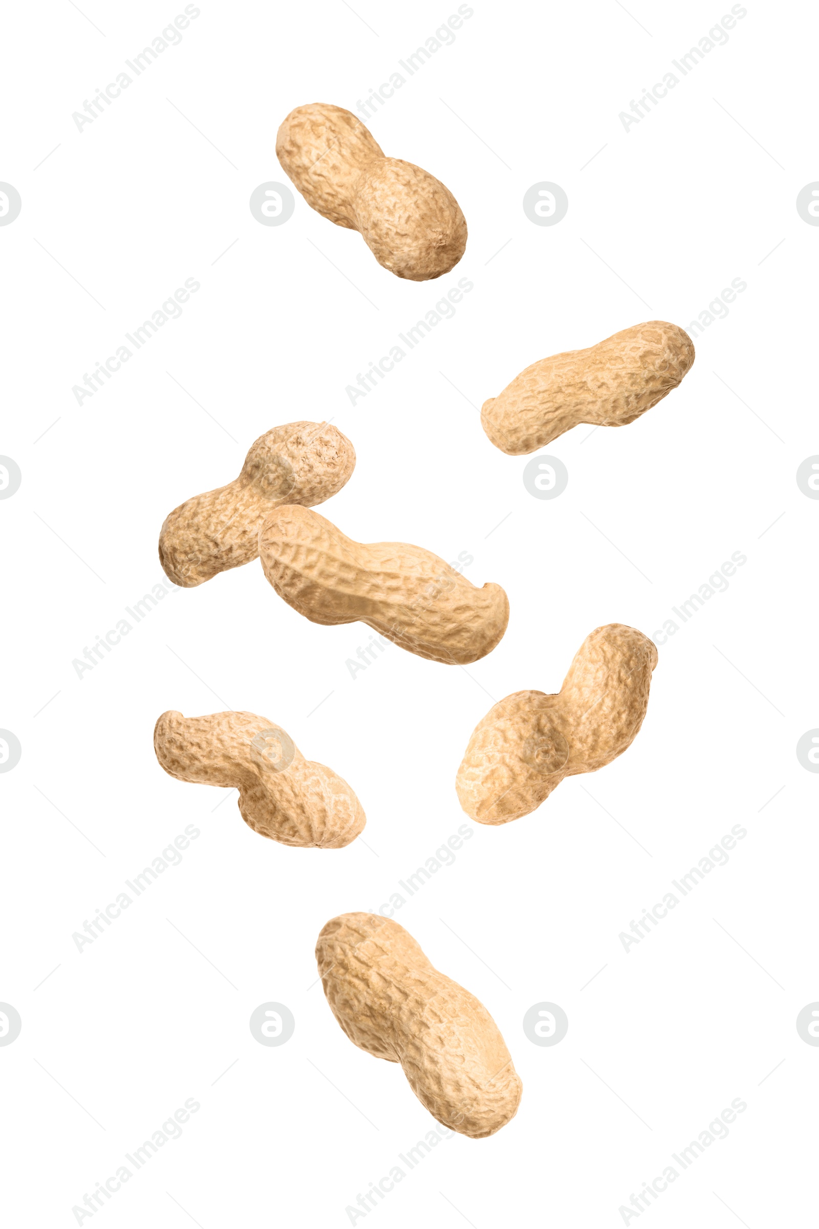 Image of Unpeeled peanuts in air on white background