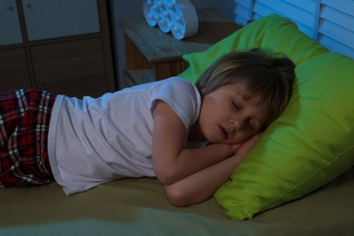 Photo of Little boy snoring while sleeping on bed at night