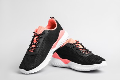 Photo of Pair of comfortable sports shoes on light grey background