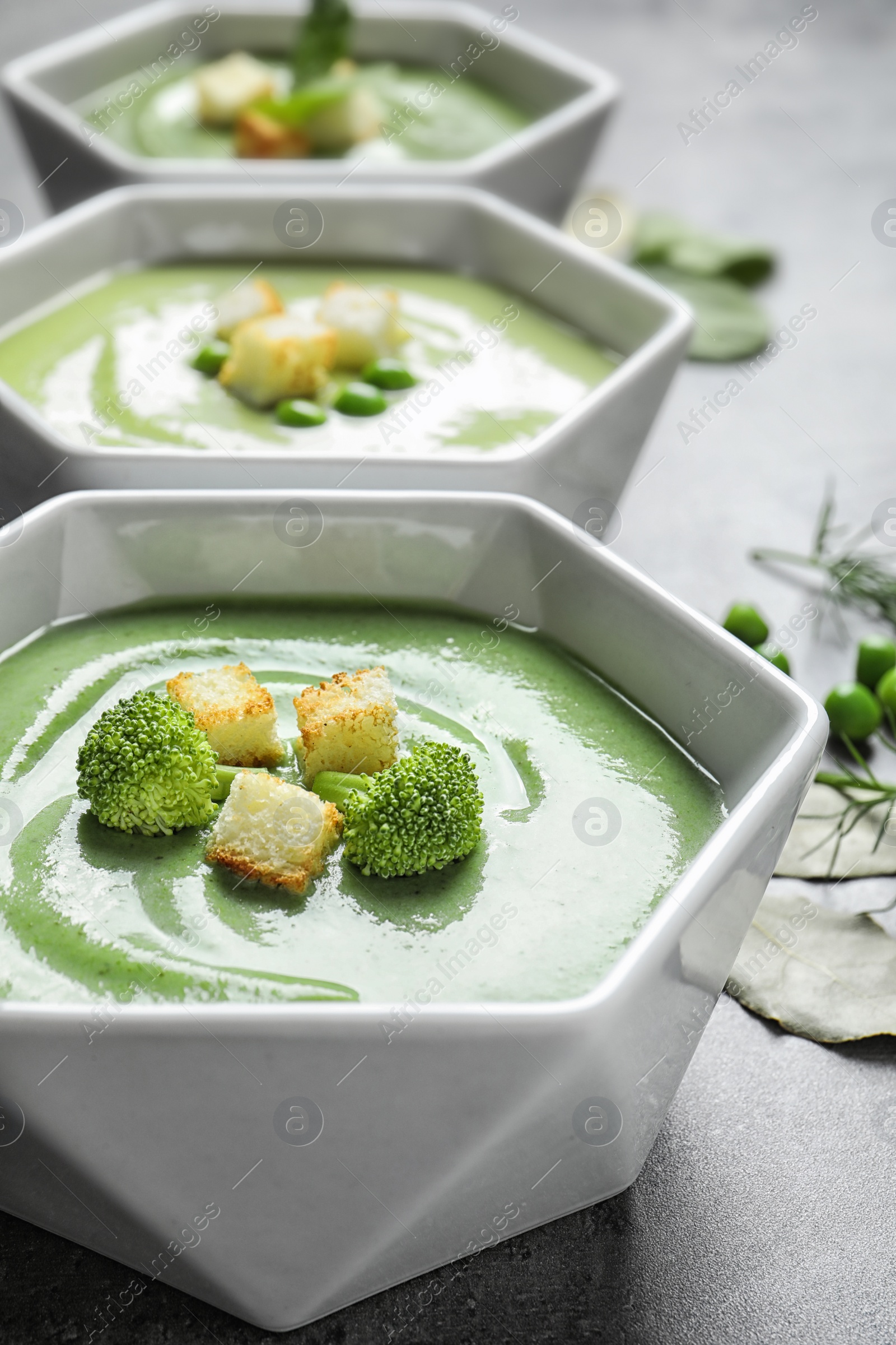 Photo of Fresh vegetable detox soup made of broccoli with croutons on table