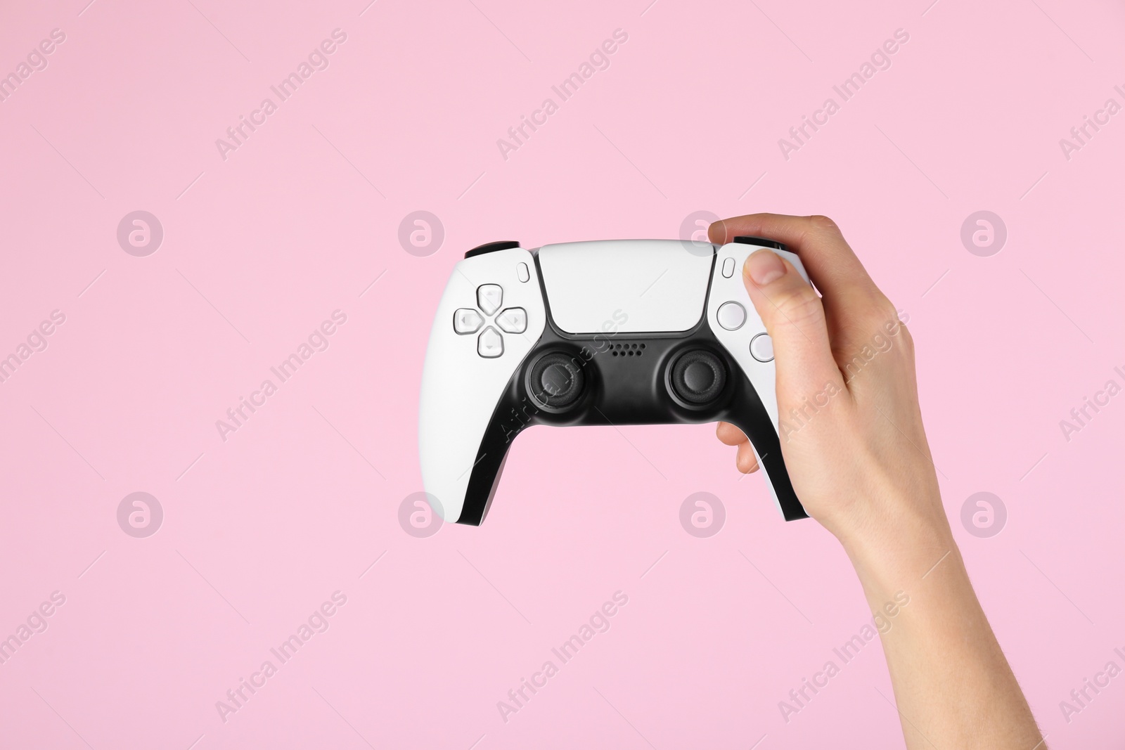 Photo of Woman with game controller on pink background, closeup