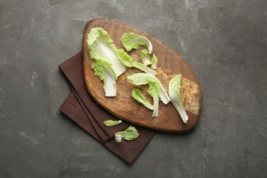 Pieces of fresh Chinese cabbage on gray textured table, top view