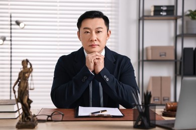 Photo of Notary working at wooden table in office