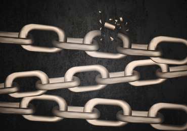 Image of Broken metal chains on black background. Freedom concept 