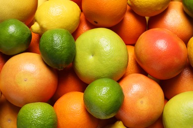 Photo of Different fresh citrus fruits as background, top view