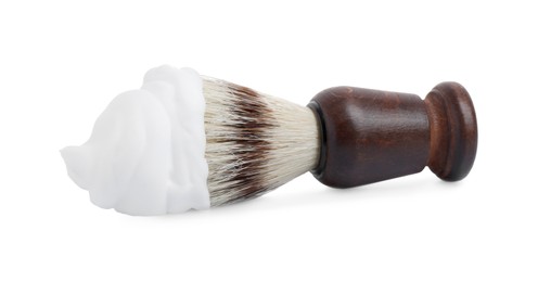 Photo of Shaving foam and brush on white background