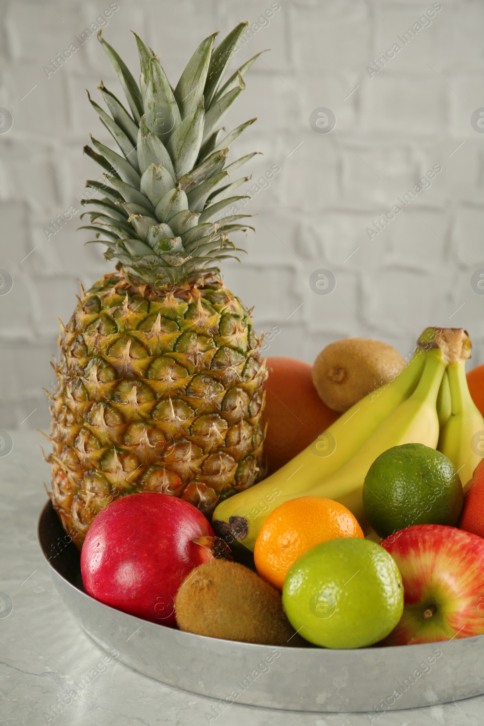 Photo of Tray with different ripe fruits on grey table