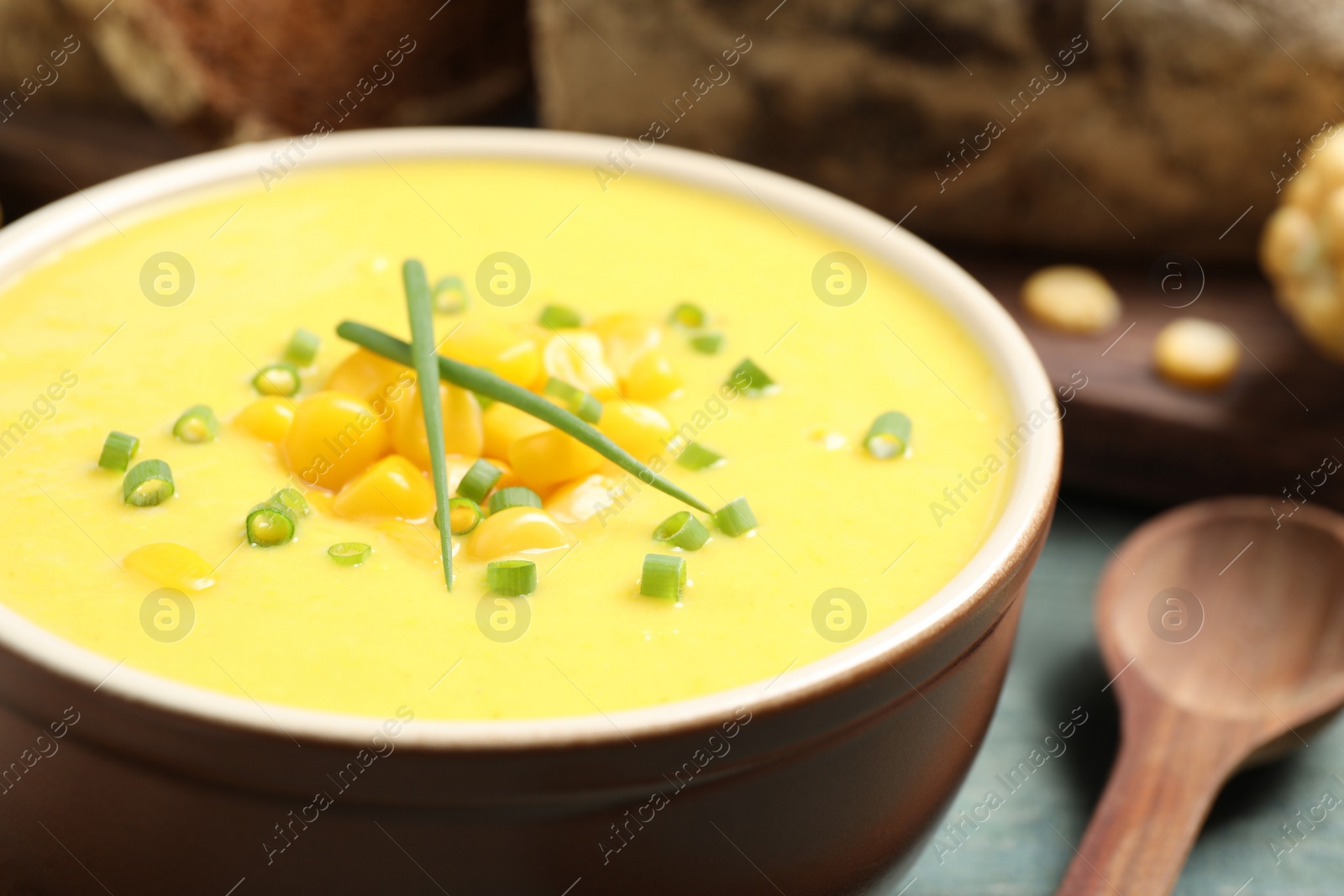 Photo of Delicious creamy corn soup on table, closeup