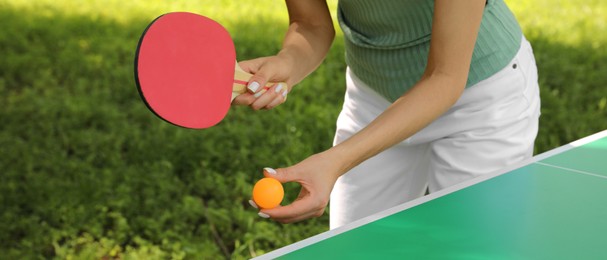 Image of Young woman playing ping pong in park, closeup. Banner design