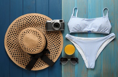Photo of Flat lay composition with beach objects on blue wooden background