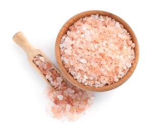 Wooden bowl and scoop with pink salt on white background, top view