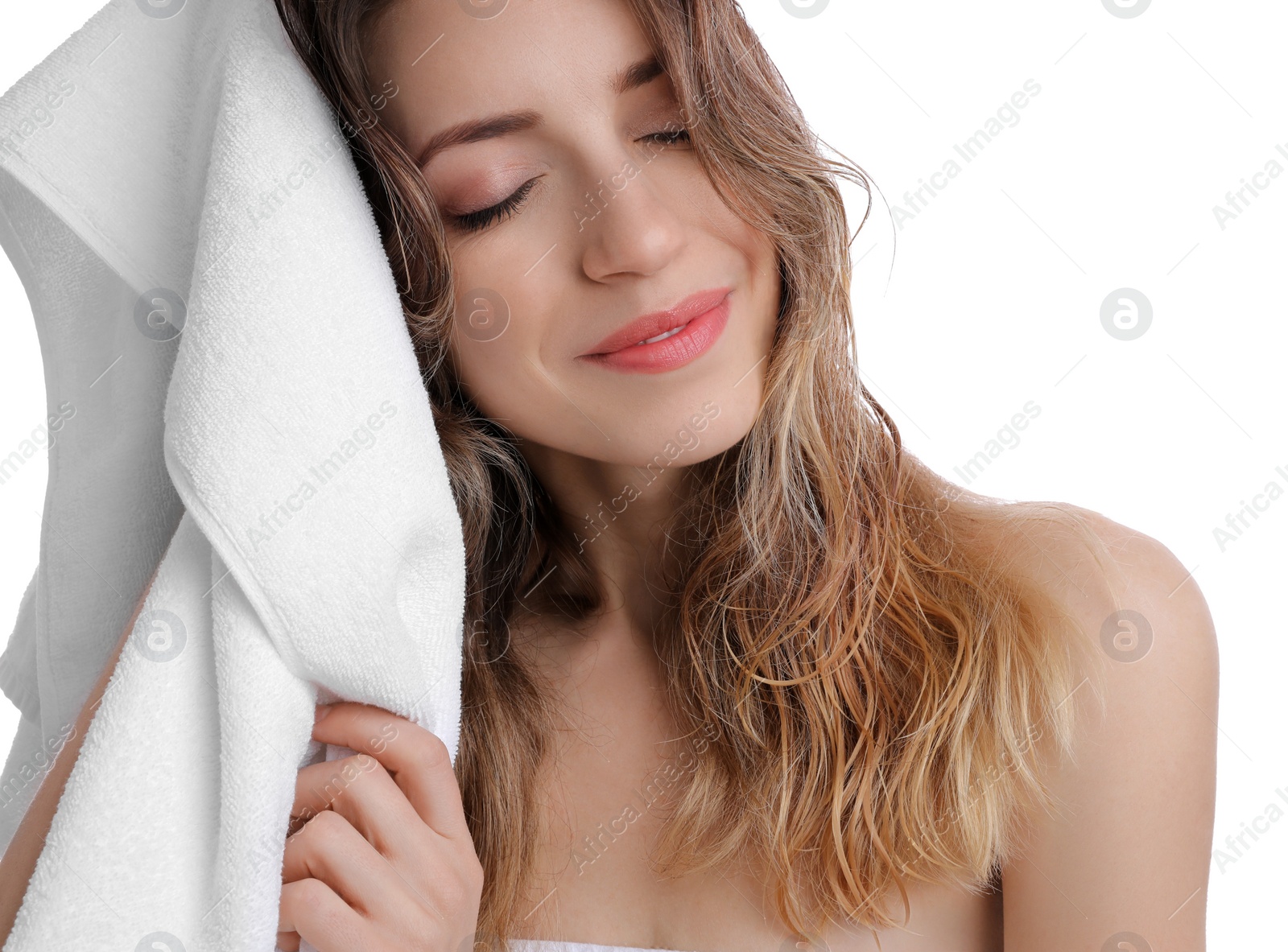 Photo of Beautiful young woman wiping hair with towel after washing on white background, closeup