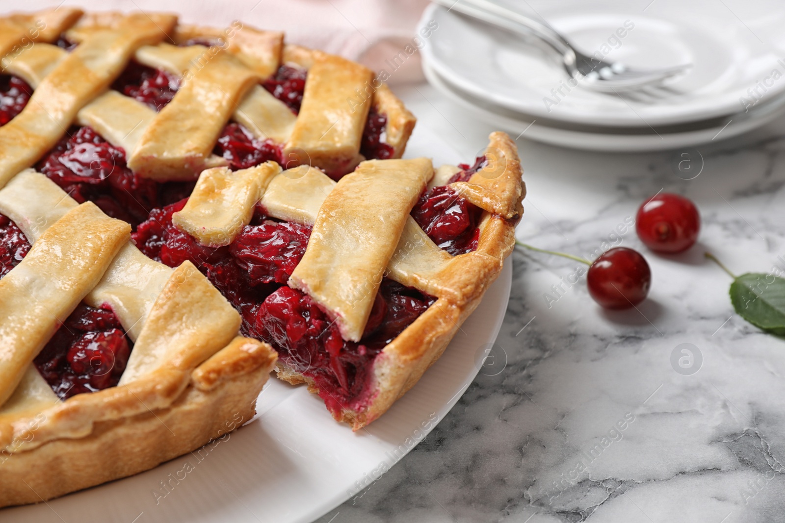 Photo of Delicious fresh cherry pie on white marble table, closeup