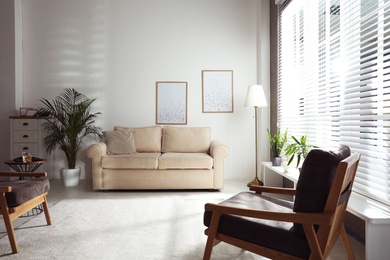 Living room interior with comfortable sofa near window