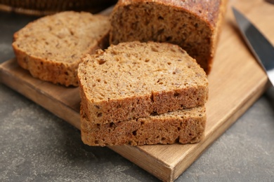 Photo of Tasty freshly baked bread on grey table, closeup