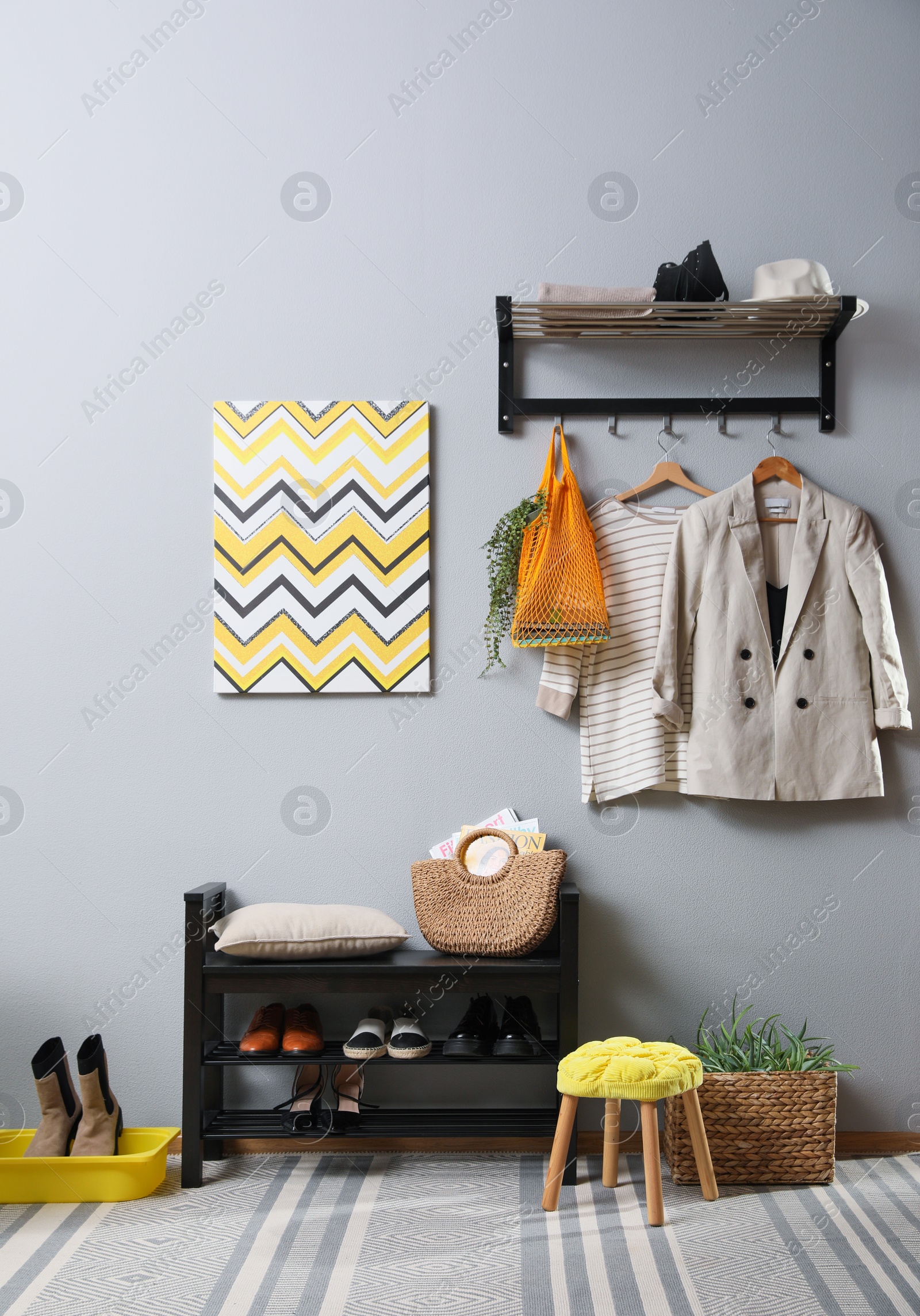 Photo of Hallway interior with stylish furniture, clothes and accessories