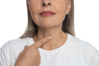 Endocrine system. Senior woman doing thyroid self examination on white background, closeup