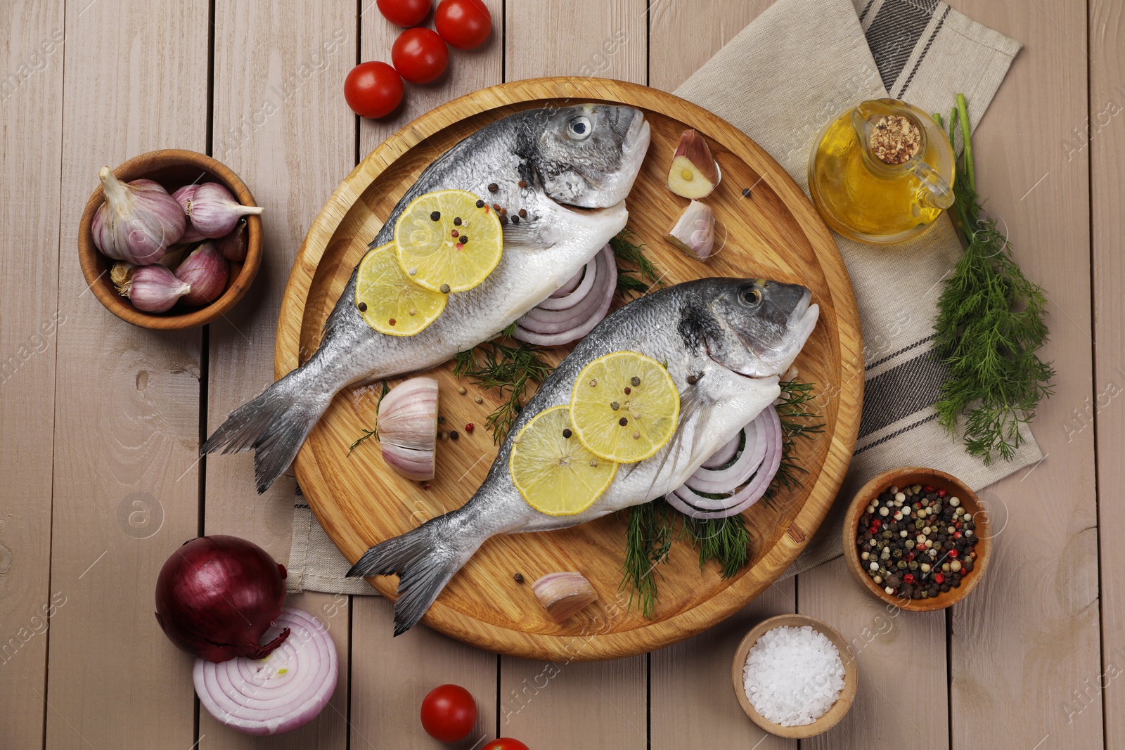 Photo of Flat lay composition with raw dorado fish on wooden table