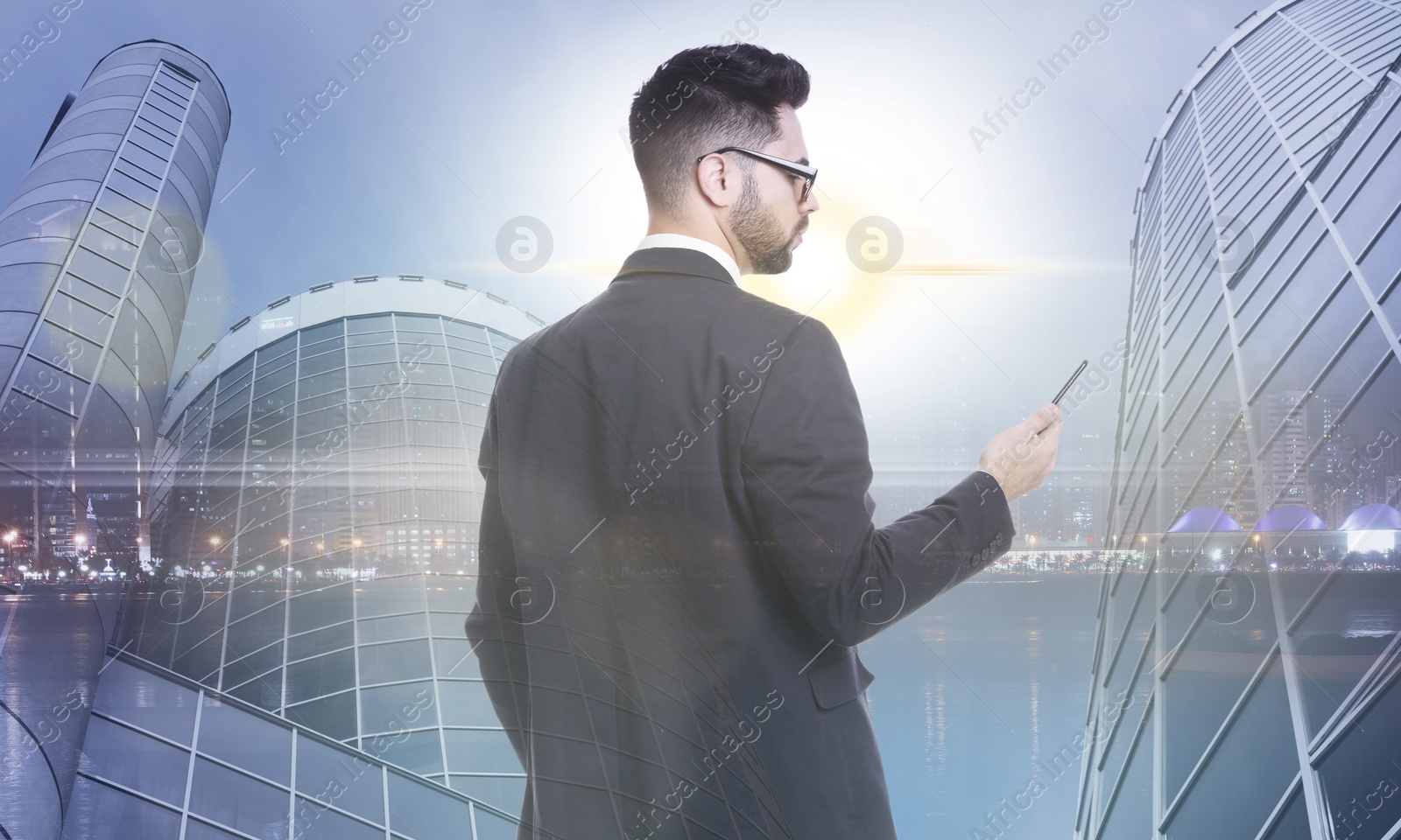 Image of Double exposure of businessman with smartphone and cityscape