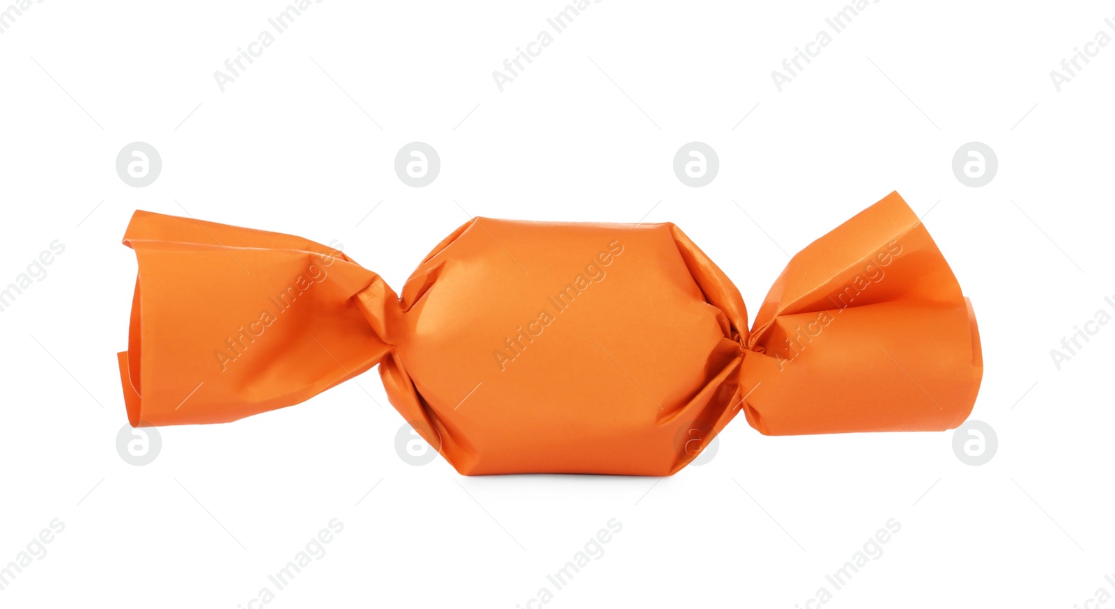 Photo of Delicious candy in orange wrapper isolated on white