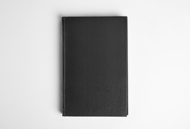 Photo of Hardcover book on white background, top view. Space for design