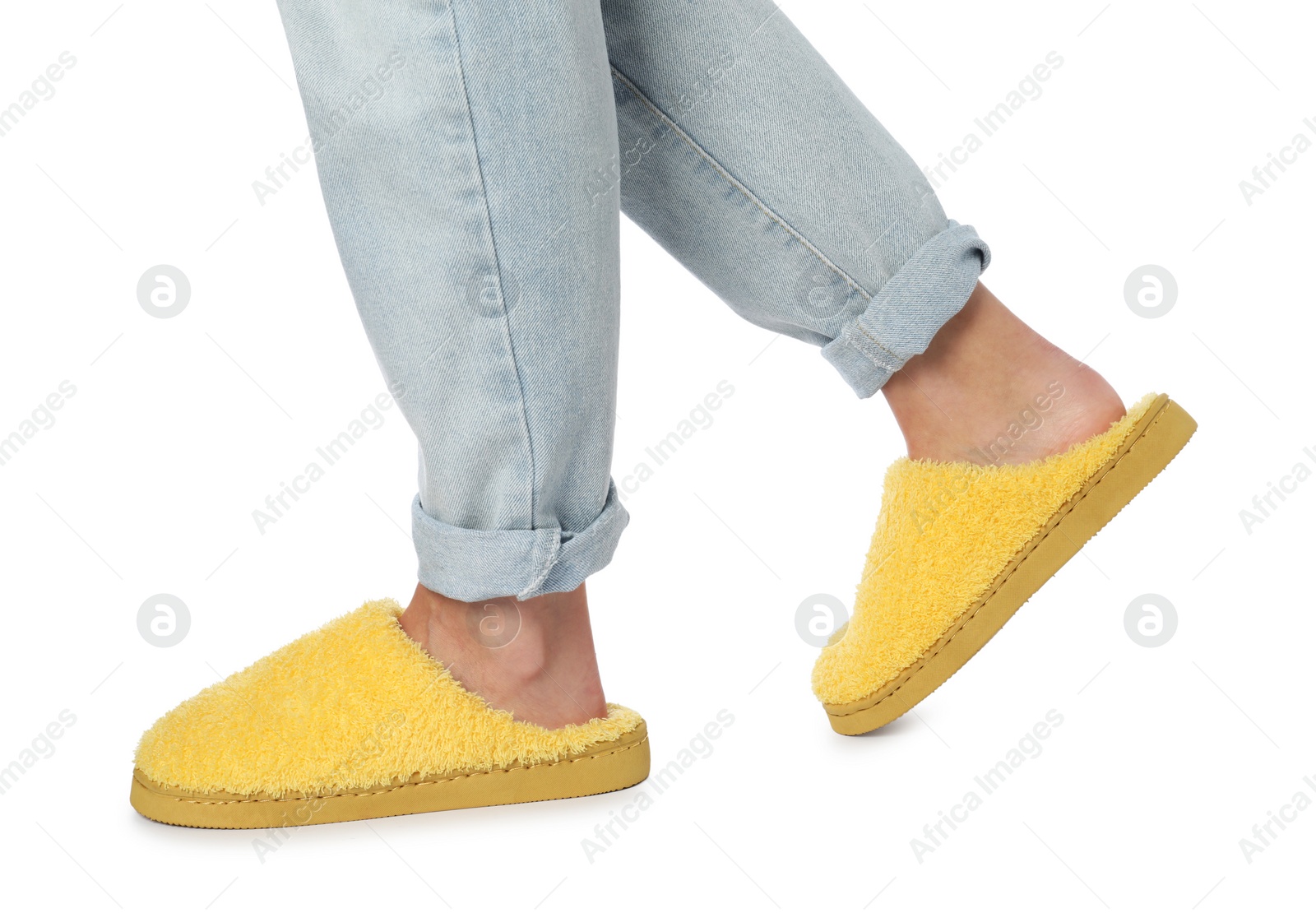 Photo of Woman in yellow soft slippers on white background, closeup