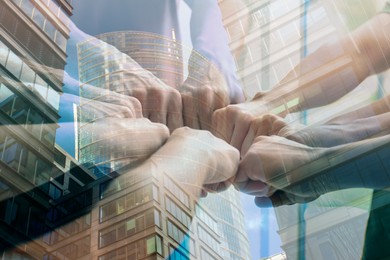 Image of Partnership concept. Double exposure of people joining hands together and buildings