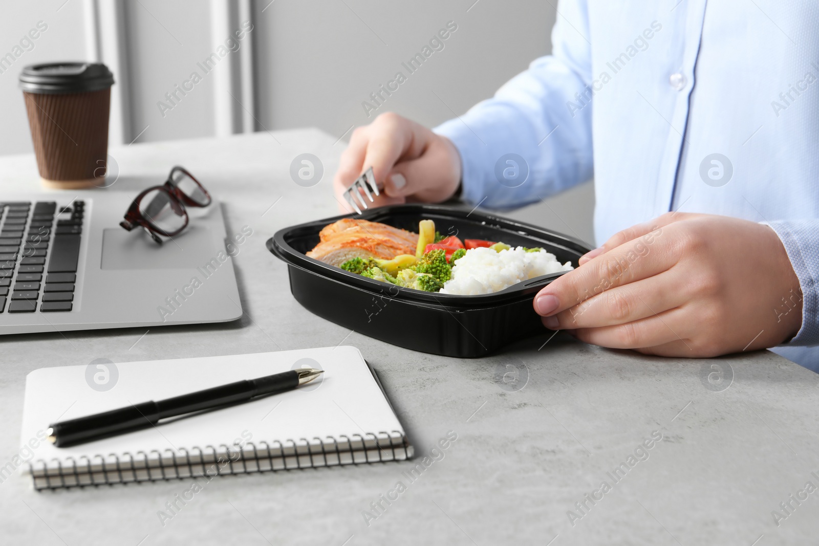 Photo of Office employee having business lunch at workplace, closeup