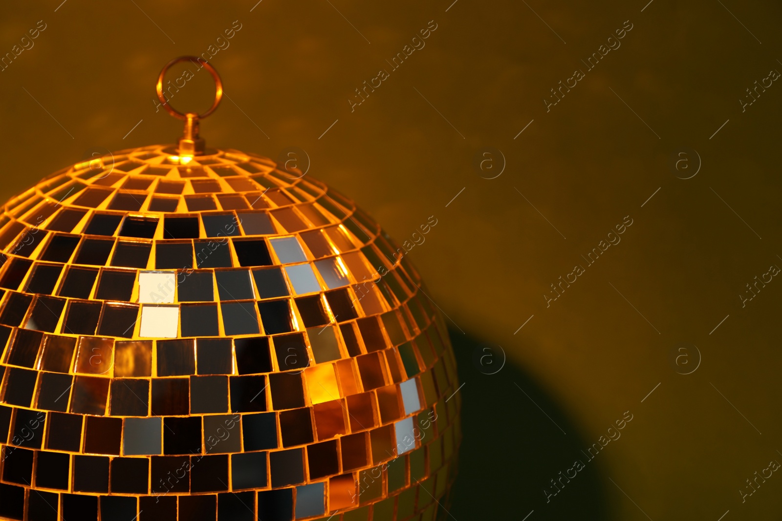 Photo of Shiny disco ball on color background, closeup. Space for text