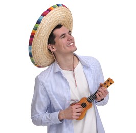 Young man in Mexican sombrero hat playing ukulele on white background