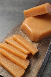 Tasty sweet quince paste on grey table, closeup