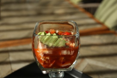 Photo of Delicious campechana cocktail with shrimps on table, closeup